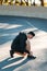 Young sportsman tying shoelaces on sneakers