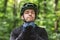 Young sportsman wearing helmet over forest background