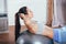 Young sportswoman doing exercises with ball on a mat at home