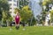 Young sportswoman performing exercises on the grass in a city