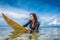 young sportswoman in wetsuit on surfing board in ocean at Nusa dua Beach