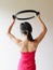 Young sporty attractive woman doing pilates toning exercise for arms and shoulders with ring, fitness with pilates magic circle