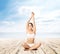 Young, sporty and beautiful girl meditating on a pier at summer. Yoga concept.