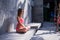 Young, sporty and beautiful girl meditating on a pier at summer. Yoga concept.