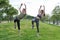 Young sporty couple stretching outdoors on the grass