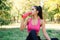 Young sporty female taking energy drink after long workout