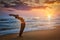 Young sporty fit man doing yoga Sun salutation Surya Namaskar