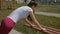 Young sporty girl doing push-ups outdoors