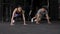 Young sporty girl and guy doing physical exercise in gym slow motion.