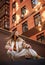 Young sporty teenager girl on roof of high-rise apartment building on brick wall background