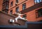 Young sporty teenager girl on roof of high-rise apartment building on brick wall background