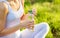 Young sporty woman drinking water after workout or running outdoor