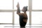Young sporty woman practicing yoga, urdhva mukha paschimottanasa