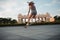 Young sporty woman riding on the longboard in the park.