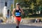 Young sporty woman running in marathon competition