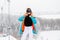 Young sporty woman in winter with snowboard, glasses