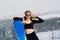 Young sporty woman in winter with snowboard, glasses