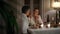 Young spouses flirting at night candles room closeup. Woman enjoying man touches