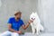 Young Sri Lankan and his fluffy white dog.