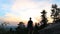 Young standing, celebrate on stone rock in czech landscape at sunset