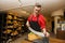 Young store clerk cutting cheese at counter