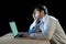 Young stressed businessman working on desk with computer laptop in frustration and depression