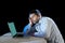 Young stressed businessman working on desk with computer laptop in frustration and depression