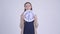 Young stressed pregnant woman holding wall clock and looking shocked