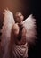 Young strong angel with white wings from heaven. Angel with muscular body. Sensual man