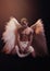 Young strong angel with white wings from heaven. Angel with muscular body. Sensual man