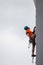 A young, strong climber climbs the wall at competitions