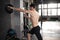 Young strong fit muscular man doing throwing medicine ball up on the wall for crossfit training hard core workout in gym