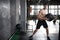 Young strong fit muscular man doing throwing medicine ball up on the wall for crossfit training hard core workout in gym