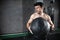 Young strong fit muscular man doing throwing medicine ball up on the wall for crossfit training hard core workout in gym