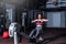 Young strong fit sweaty powerful attractive muscular woman with big muscles doing hard core row heavy cross training workout on in