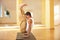 A young strong man doing handstanding yoga exercises - Urdhva Brahmachariasana in yoga studio
