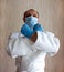 A young strong man in a white kimono for sambo, jiu jitsu and other martial arts with a blue medical gloves and medical mask.