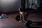 Young strong muscular fit girl with big muscles preparing for hard strength weight lifting or dead lift cross workout training wit