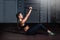 Young strong serious sweaty focused athlete fit muscular woman with big muscles holding heavy kettlebell weight barbell dumbbell