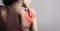 Young strong sporty woman suffering from pain in shoulder in sport wear. Touching the hand. Sports exercising injury. Closeup