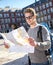 Young student backpacker tourist looking city map in holidays travel