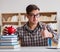 Young student breaking piggy bank to buy textbooks