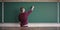 Young student in casual writing physics formula on empty blank blackboard during study course copy space mock up