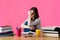 Young student with desperate expression sitting at her desk.