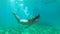 Young student female swimming underwater and having fun in summer