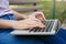 Young student girl typing on laptop. Female hand. Crop, closeup