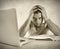 Young student man in stress overwhelmed studying exam with book and computer