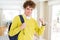 Young student man wearing headphones and backpack screaming proud and celebrating victory and success very excited, cheering