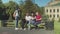 Young students studying sitting on park bench