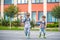 Young students, two sibling brothers, going to school.